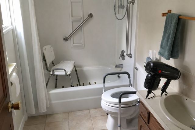 bathroom: Plugged-in hair dryer by the sink